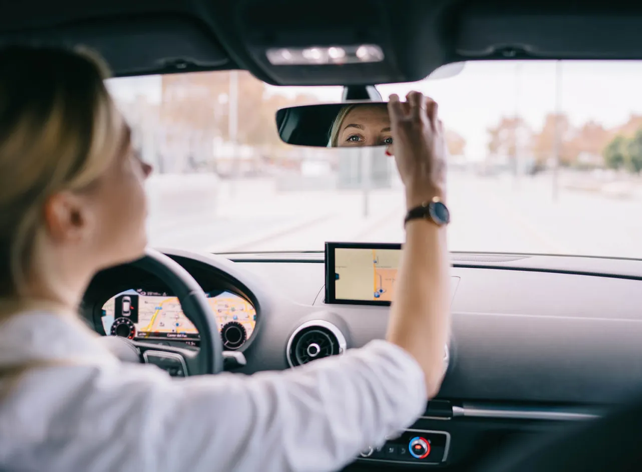 woman checking rear-view mirror